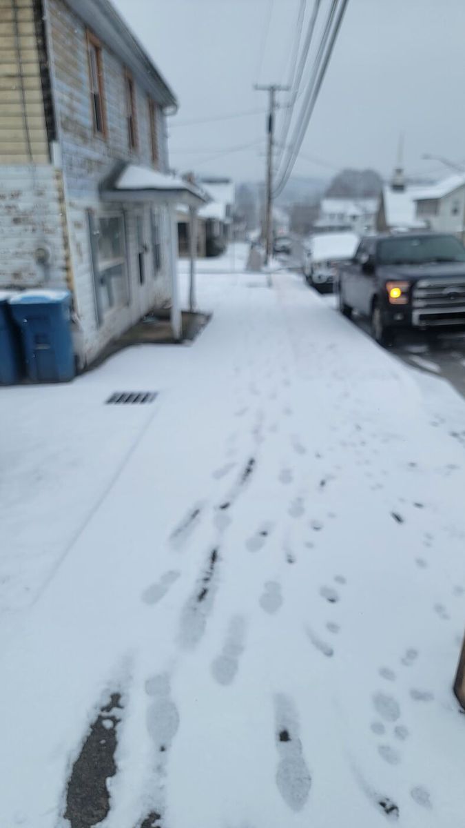 Snow-covered sidewalk before